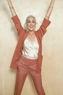 Positive Emotion Prints: A middle-aged woman with grey hair smiling with her hands up