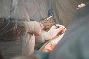 Team Work Prints: Midsection of medical team performing surgery in operating room