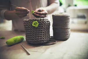 Front Views Prints: Midsection of woman knitting woolen purse at home
