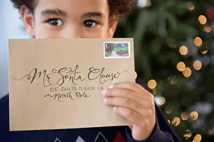 Envelope Prints: Mixed race boy holding letter to Santa for Christmas
