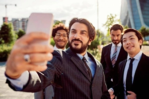 Mixed Age Range Prints: Mixed race group of businessmen hanging out together in town