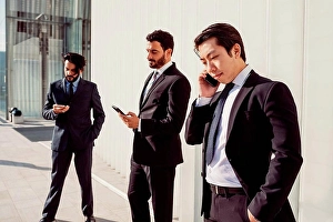 Middle Eastern Prints: Mixed race group of businessmen hanging out together in town