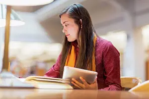Joining Prints: Mixed race student studying in library