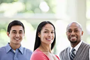 Bald Prints: Mixed race team of business people at a table in a business centre