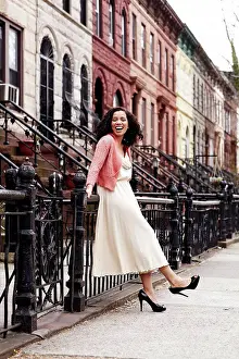 Chic Prints: Mixed race woman smiling on city street