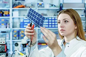 Technician Prints: MODEL RELEASED. Girl holding film solar cells