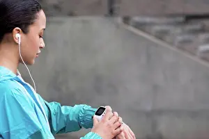 Sports Clothing Prints: MODEL RELEASED. Young woman checking watch