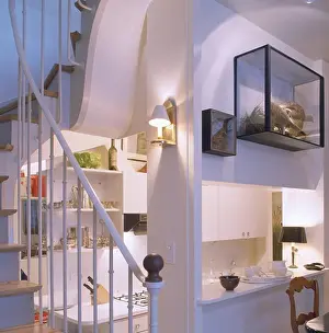 Stairs Prints: Modern white understairs kitchen with glass case on wall above hatch