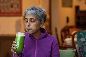 Vegetables Prints: A modern woman sipping fresh green juice using a re-usable metal straw