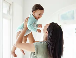 Carry Prints: Mom carrying happy baby in home for love