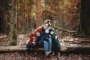 Sons Prints: Mom and children smiling happily sitting in forest in the Fall