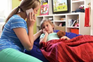 Conversation Prints: Mom with daughter who is not feeling well using cell phone to consult doctor and get advice via Telemedicine service