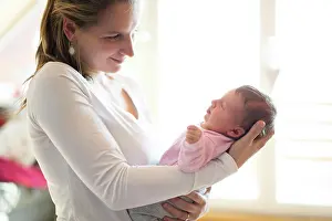 Parenting Prints: Mom holding newborn baby, looking at infant lovingly
