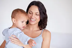 Happy Woman Prints: Mom holding toddler in home with smile