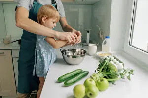 Parenting Prints: Mom teaches her little daughter how to cook dinner