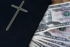 Money Prints: Money and religion. Banknotes of US dollars with Holy Bible