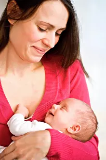 Brown Haired Prints: One month old baby sleeping in mother's arms