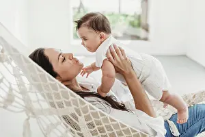1 2 Years Old Prints: Mother and baby daughter playing in hammock in natural light studio