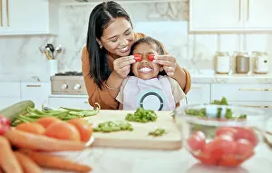 Vegetables Prints: Mother, child and have fun cooking in kitchen together with teamwork to cut chillies