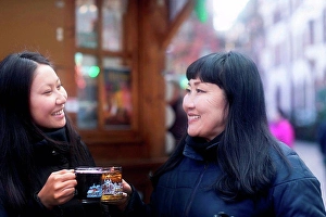 Reality Prints: Mother and daughter drinking at Christmas market, Freiburg, Baden-Wurttemberg, Germany