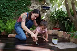 Maintenance Prints: mother and daughter enjoy painting the wood floor together