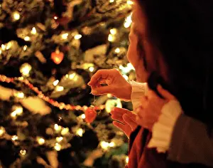 Daughter Prints: Mother and daughter hanging decorations on a Christmas tree