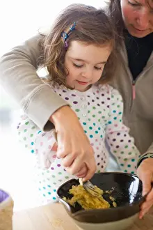 Radius Images Prints: Mother and Daughter Preparing Food in Kitchen