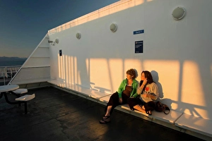 Motor Prints: Mother and Daughter share a moment together alongside the setting sun while aboard BC Ferry bound for Vancouver