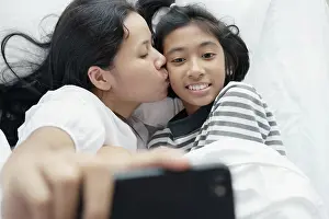 Cellphone Prints: mother and daughter are taking a picture together