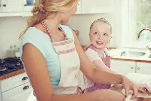 Bake Prints: Mother, girl and dough for cake in kitchen