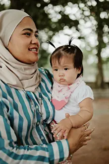 Grandfather Prints: Mother holding baby girl in the park