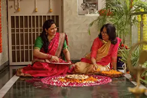Occasion Prints: Mother-in-law and daughter-in-law decorating house with lamps and flowers on the occasion of Diwali