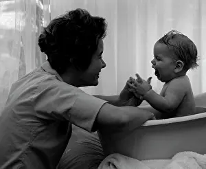 Parenting Prints: Mother playing with baby in baby bathtub