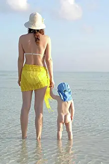 Trips Prints: Mother and small child standing in shallow water