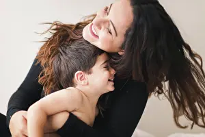 Parenting Prints: Mother and son hugging each other and laughing
