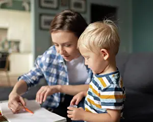 Instructor Prints: Mother spending time with little son and painting at home