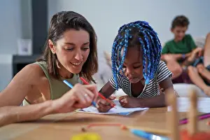 Coloring Prints: Mother and toddler daughter coloring at home