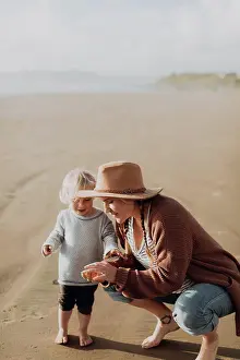 Curiosity Prints: Mother and toddler playing on beach