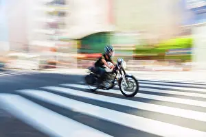 Blur Prints: Motion blurred shot of a motorbike at speed on a pedestrian crossing in Tokyo, Japan