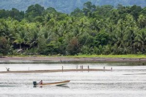 Culture Prints: Motorboat going by children playing on sandbar in Morobe Bay