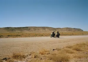 Side By Side Prints: Two motorcyclists waving