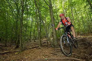 Trips Prints: Mountain bike rider riding along a root singletrail near Willingen, Hesse, Germany, Europe