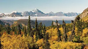 Geography Prints: Mountains in the Chugach Range stand above the clouds rising from the Valley in Alaska North America