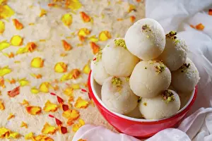 Petals Prints: Mouth watering white rasgullas kept in a bowl with sprinkled pistachios