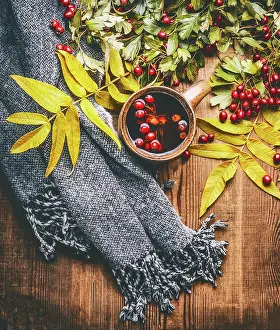 Berries Prints: Mug of herbal tea with red autumn hawthorn berries