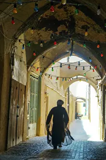 Alley Prints: Mullah hurrying down typical vaulted alleyway, Yazd, Iran, Middle East