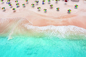 West Indies Prints: Multi colored umbrellas on tropical beach washed by waves of Caribbean Sea