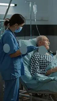 Oxygen Prints: Multi ethnic medical staff talking about treating patient