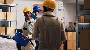 Logistics Prints: Multiethnic group of people in overalls checking goods