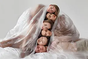 Extinction Prints: multinational people head to head covered with polyethylene